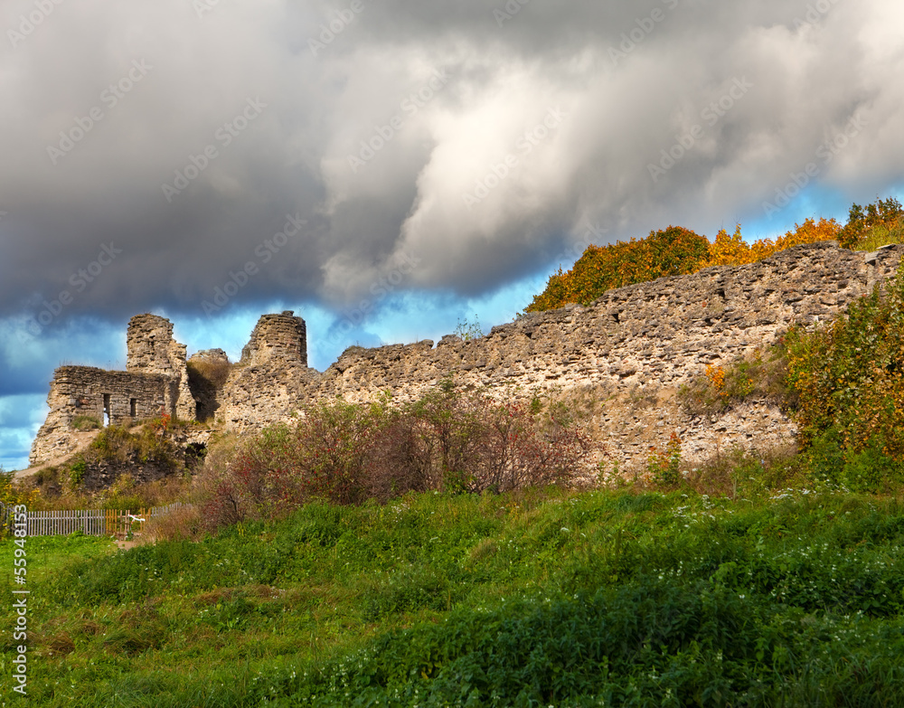 Autumn trees at the ancient destroyed fortress. Russia.