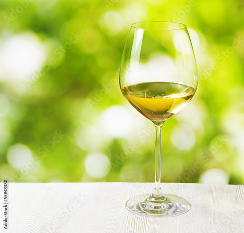 Glass of wine on nature background