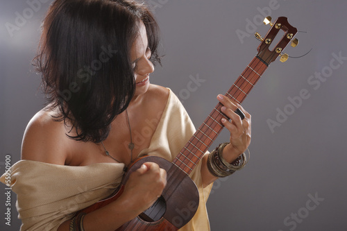 Cute four string guitar performer photo