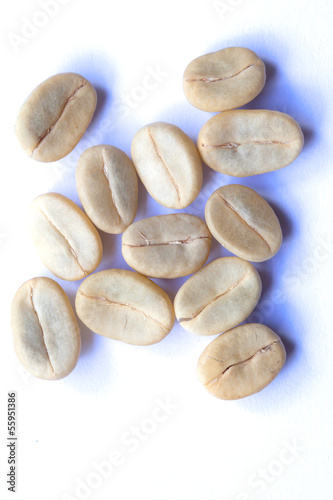 green and roasted coffee beans on white background