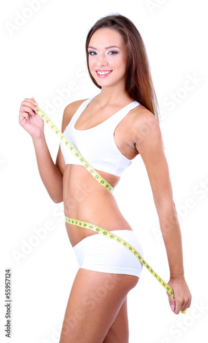 Beautiful young woman measu...