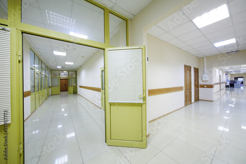 Two light white corridors with doors to offices