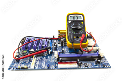 Multimeter and computer circuit board on white background