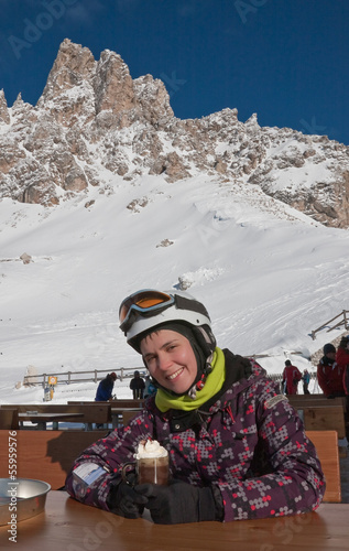 The girl at the table mountain cafe. Ski resort of Selva di Val
