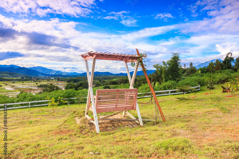 blue sky with wooden swing in the garden blue sky with wooden swing in the garden