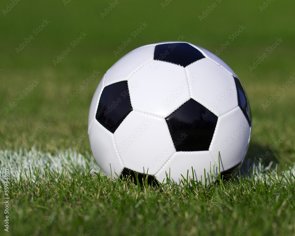 Soccer ball on the field with yard line. Football on green grass Soccer ball on the field with yard line. Football on green grass