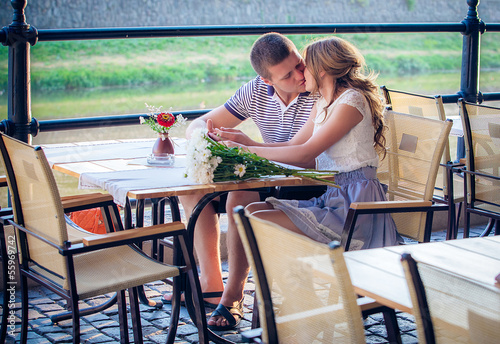 young couple in an open-air cafe