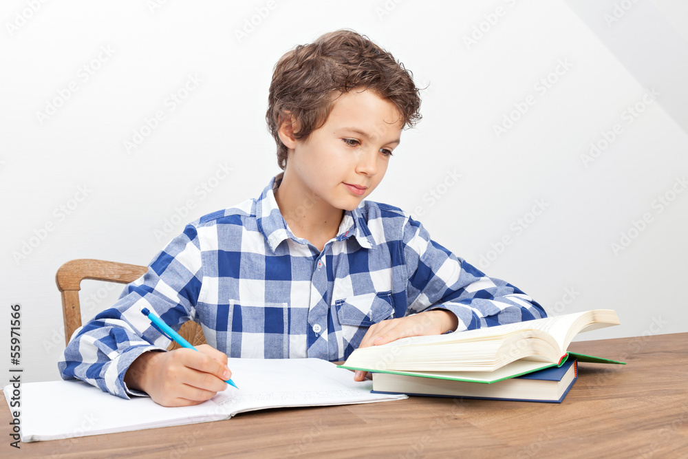 A boy is doing his homework