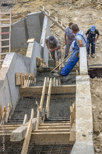 manual workers pouring concrete steps 2