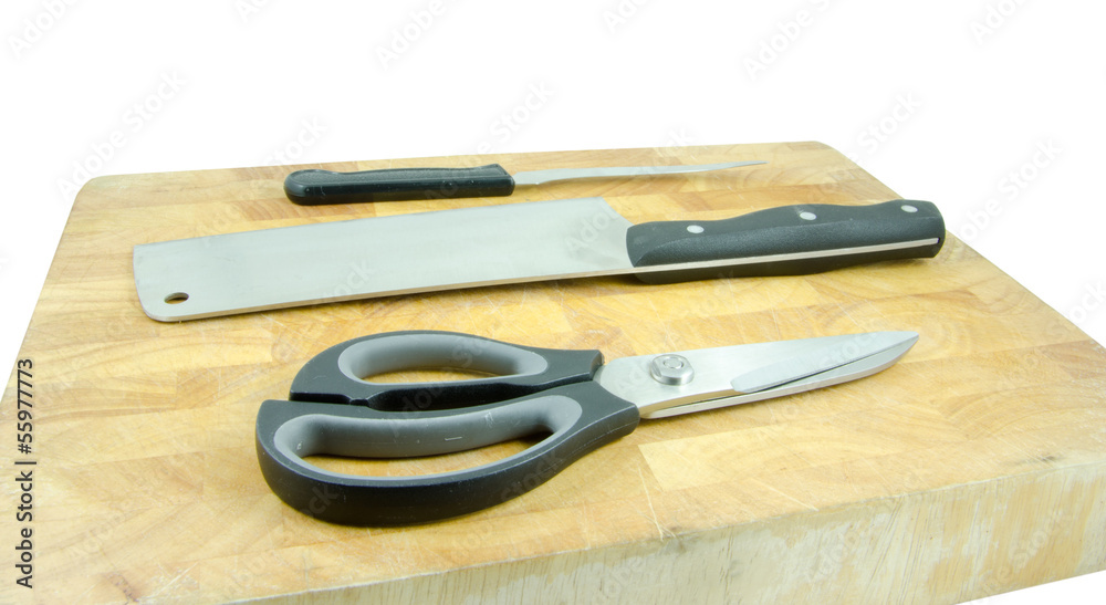 knife, cleaver and scissors on chopping block knife, cleaver and scissors on chopping block