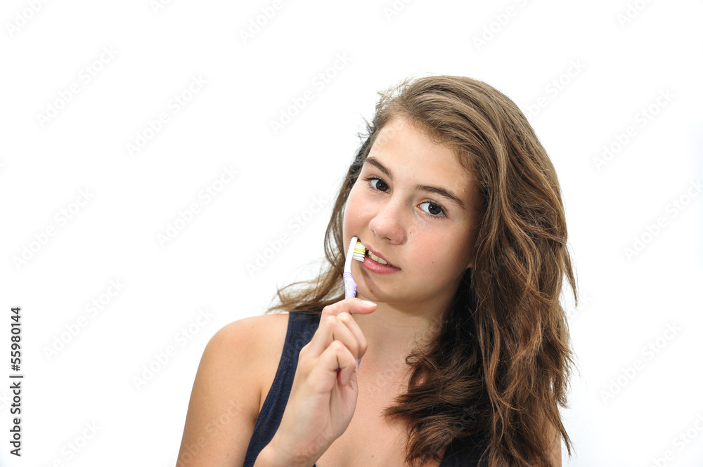 pretty smiling teen brushing her teeth isolated on white pretty smiling teen brushing her teeth isolated on white