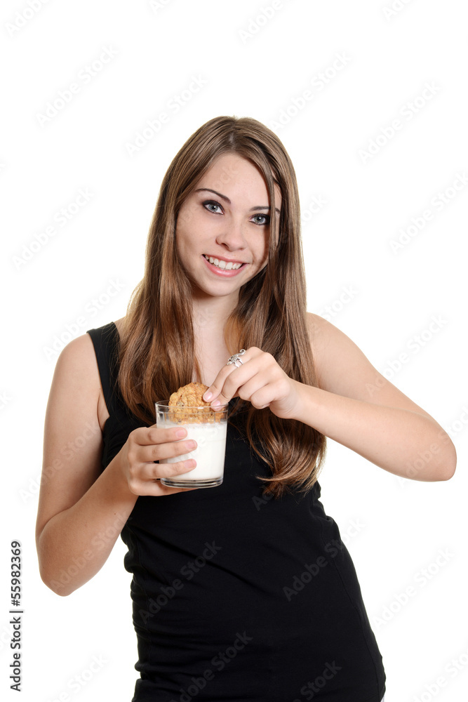 teen girl dunking oatmeal cookie in milk teen girl dunking oatmeal cookie in milk