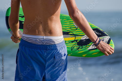 particular boy with surfboard