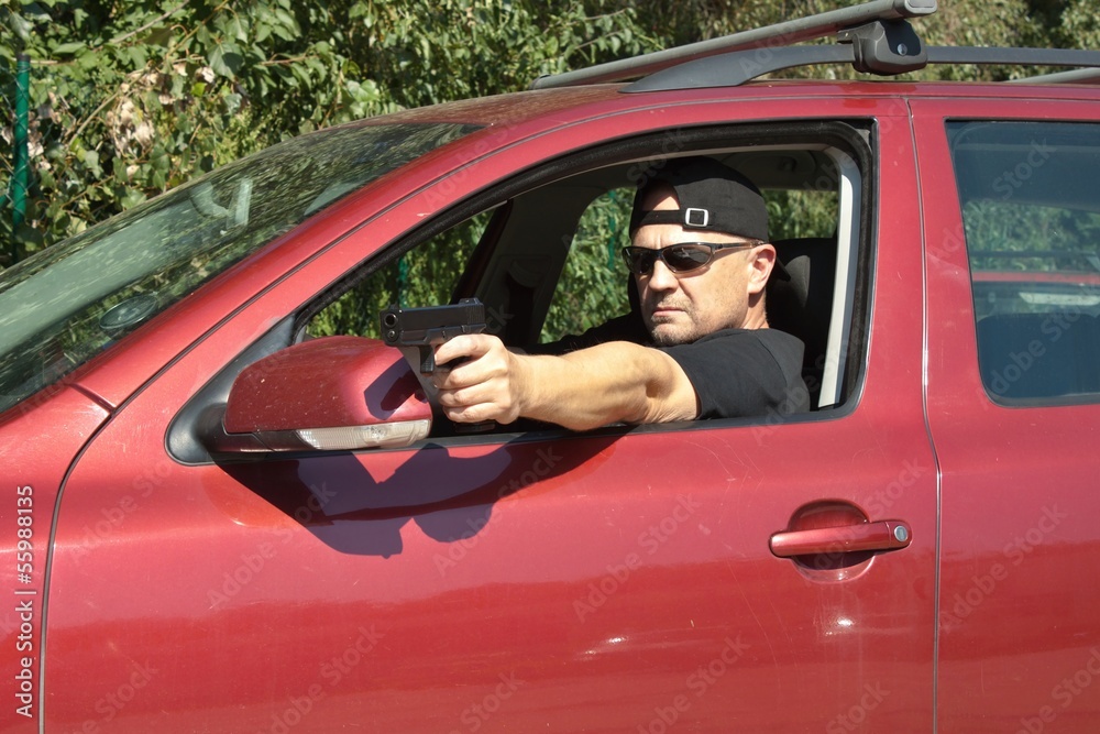 assassin shooting from a moving car, aggressive driver assassin shooting from a moving car, aggressive driver