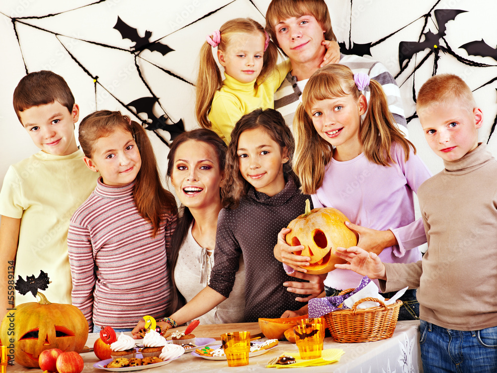 Family with child holding make carved pumpkin Family with child holding make carved pumpkin