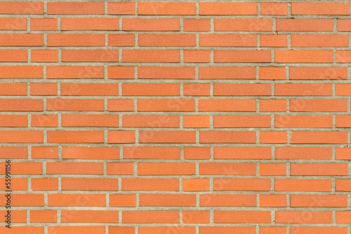 Red wall of bricks with grey seams
