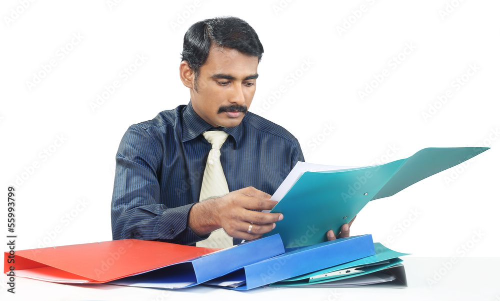 Indian businessman checking the documents Indian businessman checking the documents