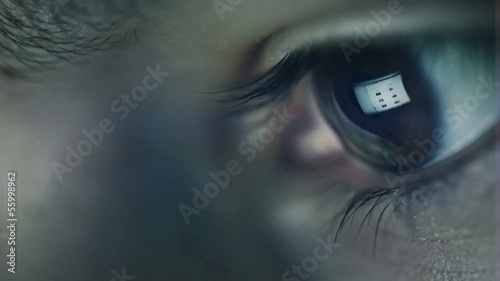Closeup shot of boy eye surfing internet at night