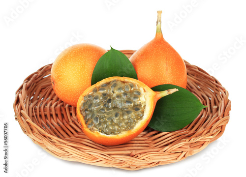 Passion fruits on wicker mat isolated on white