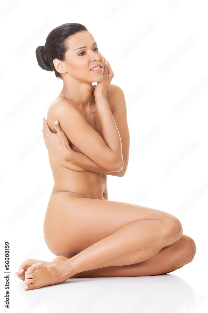 Sexy fit naked woman with healthy clean skin sitting Sexy fit naked woman with healthy clean skin sitting