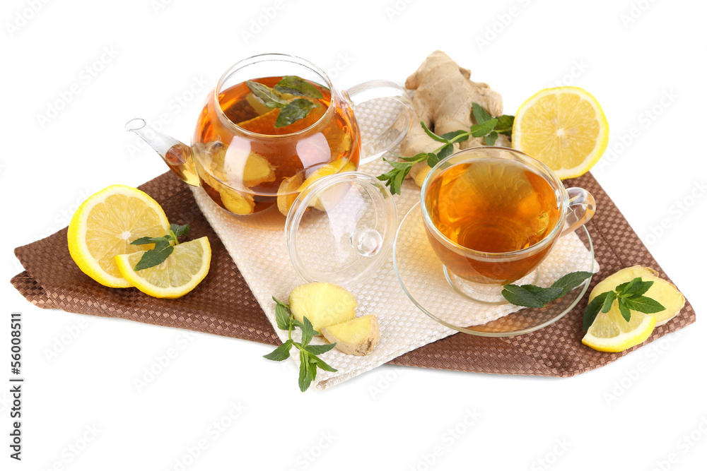 Kettle and cup of tea with ginger on napkin isolated on white Kettle and cup of tea with ginger on napkin isolated on white
