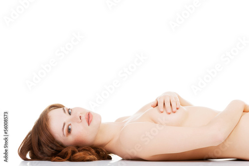 Sexy fit naked woman with healthy clean skin lying down