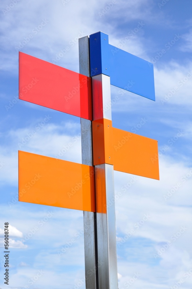 multi color road sign with cloudy sky on multi color road sign with cloudy sky on