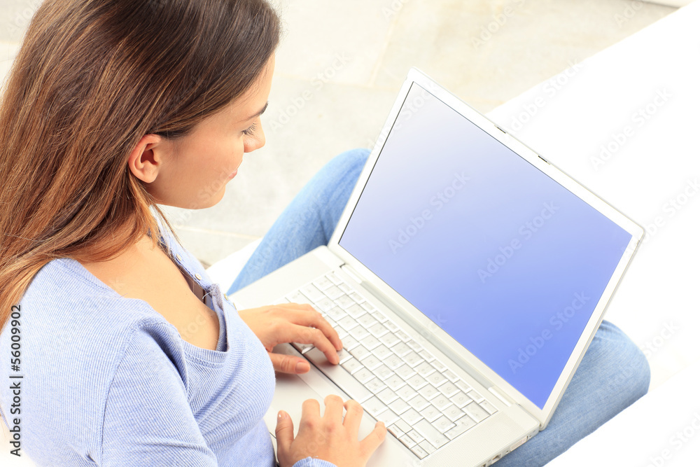Young woman smiling while working on laptop Young woman smiling while working on laptop