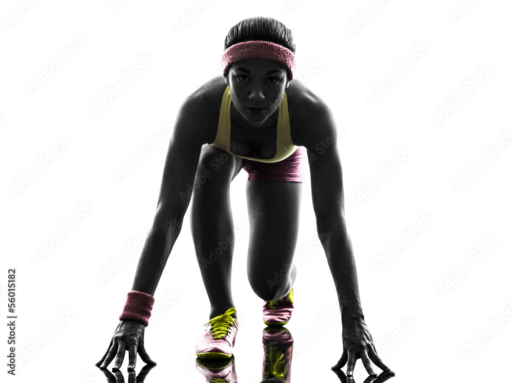 woman runner running on starting blocks silhouette woman runner running on starting blocks silhouette