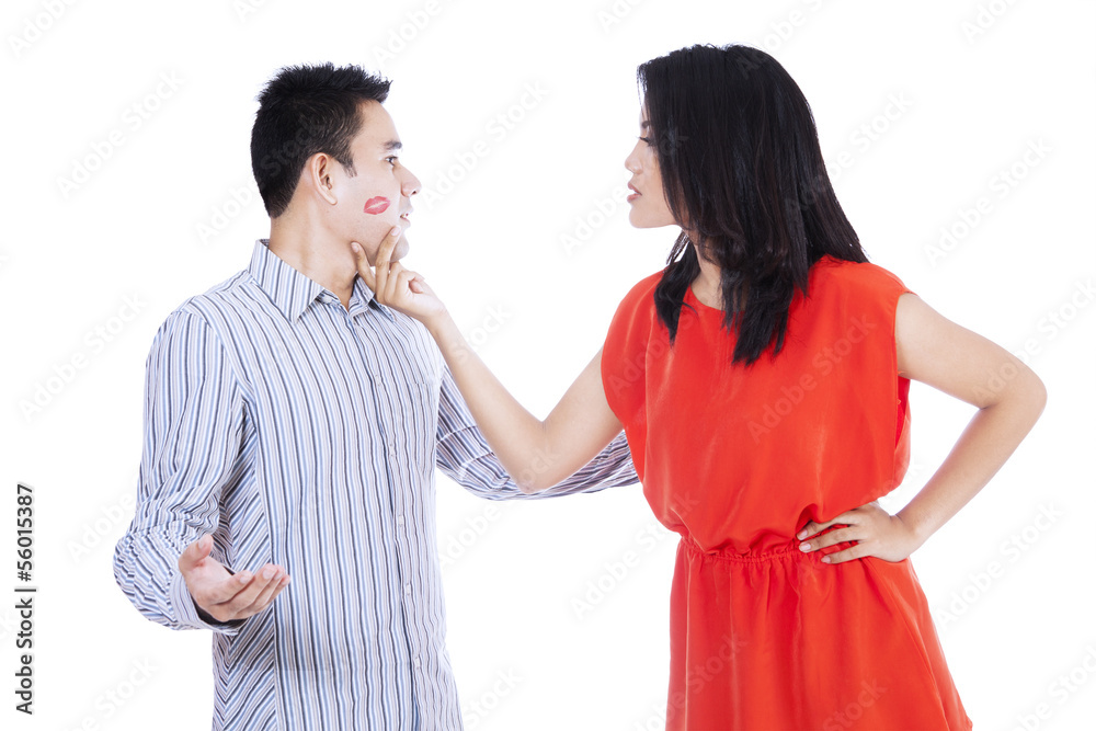Jealous woman looking at her kissed man Jealous woman looking at her kissed man