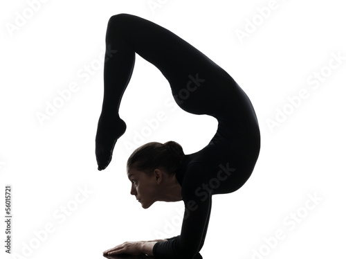 woman contortionist  exercising gymnastic yoga   silhouette