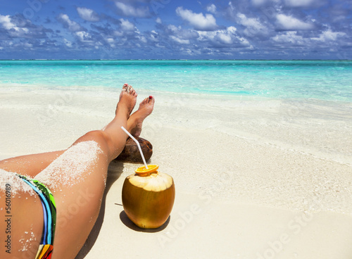 green coconut and legs of a young girl