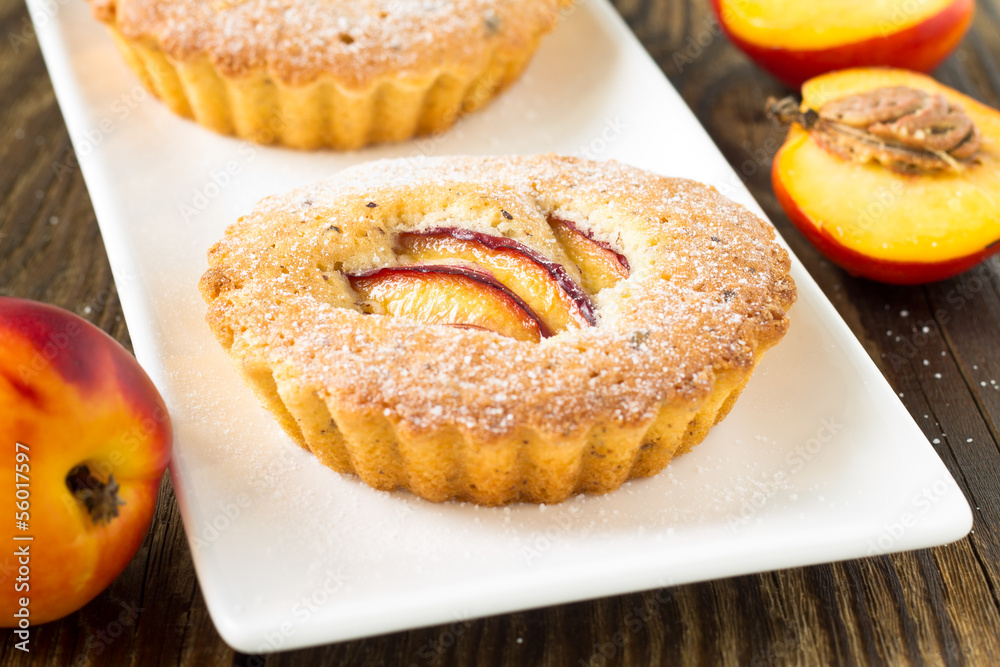 Homemade mini peach cake on white plate Homemade mini peach cake on white plate