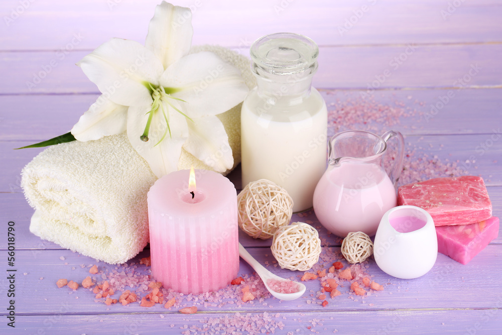 Beautiful spa setting with lily on wooden table close-up Beautiful spa setting with lily on wooden table close-up