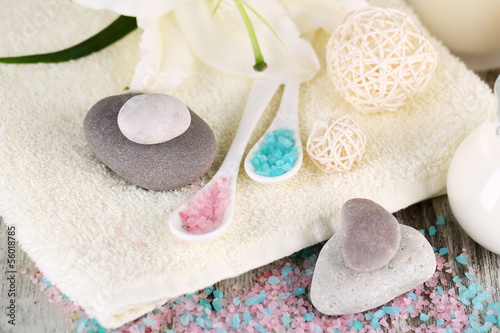 Beautiful spa setting with lily on wooden table close-up