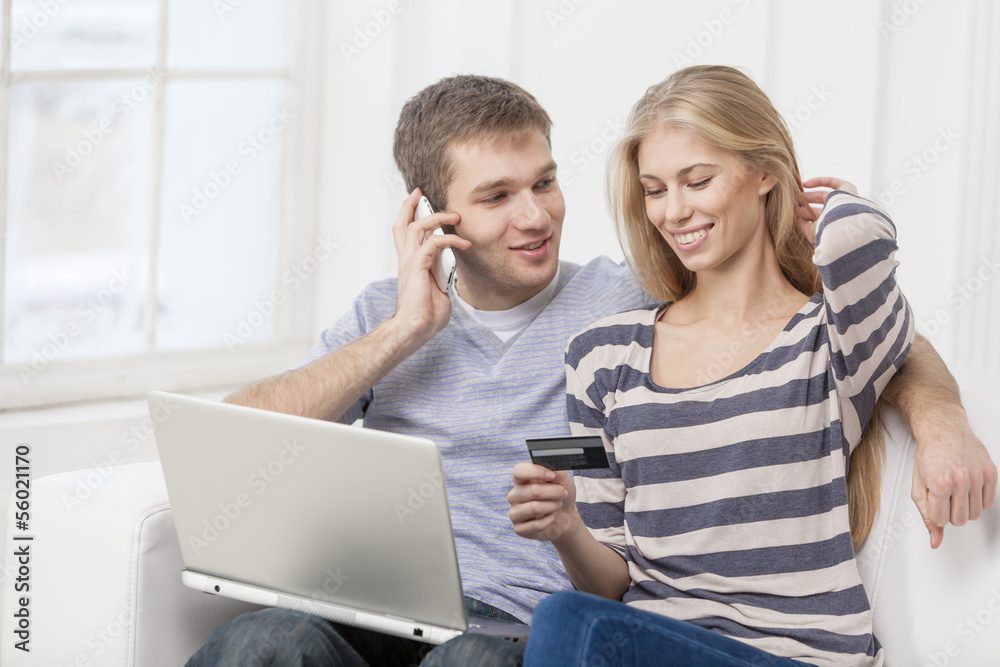 young caucasian couple sitting on couch young caucasian couple sitting on couch