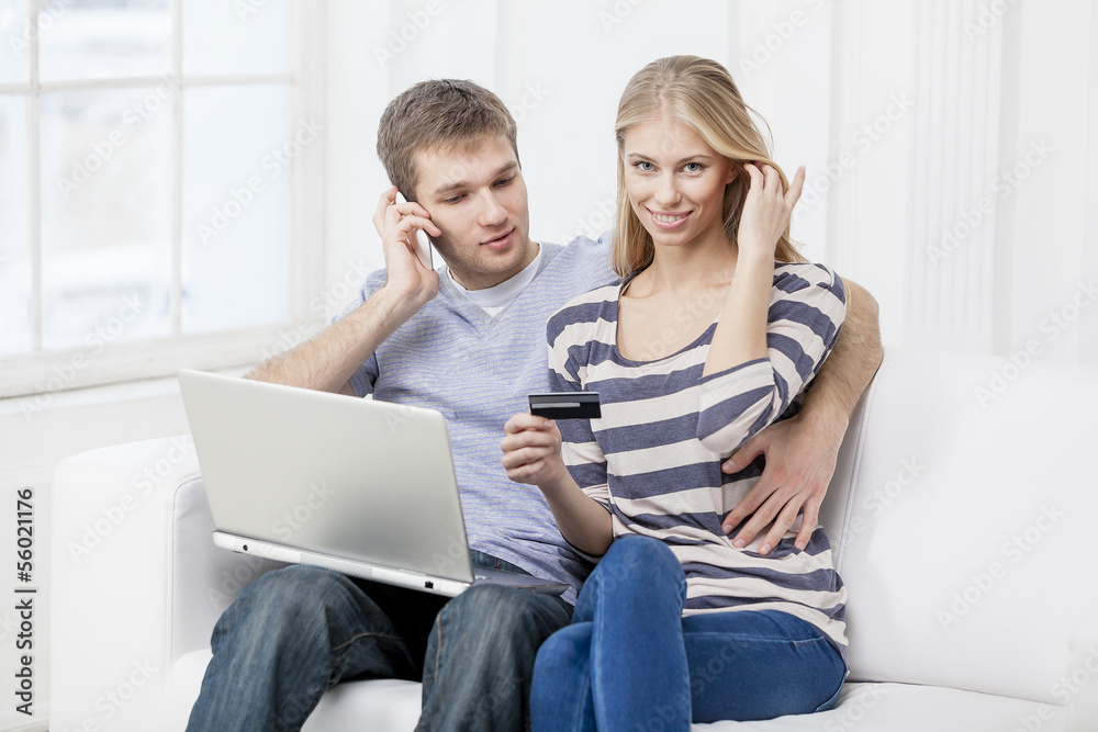 young caucasian couple sitting on couch young caucasian couple sitting on couch