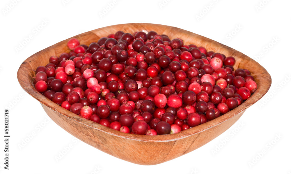 cowberry in square wooden plate. corner to the viewer. cowberry in square wooden plate. corner to the viewer.