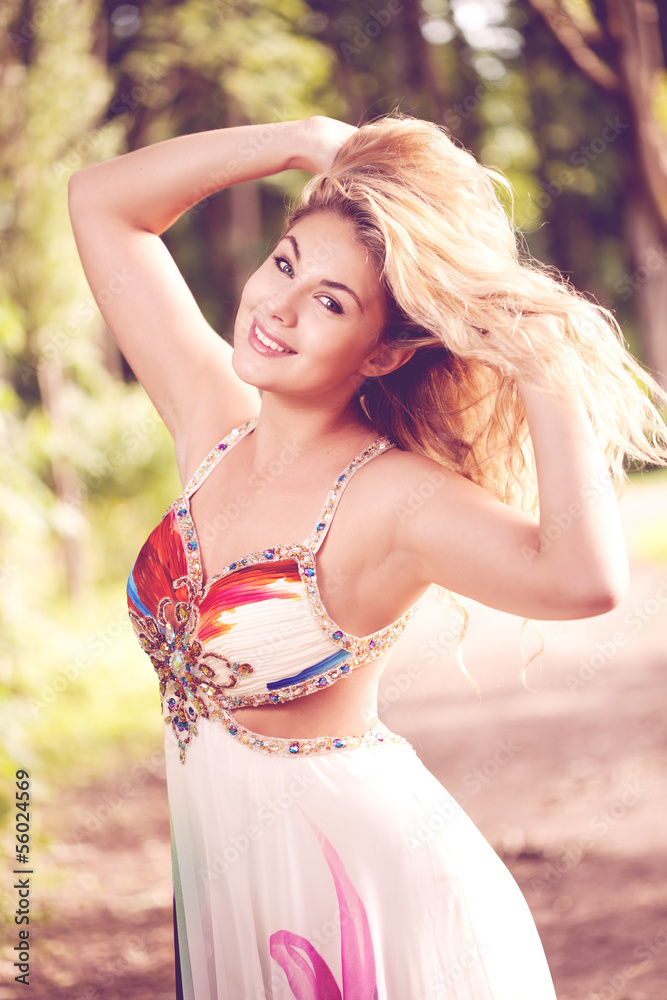 Naklejka premium Woman in a bright dress flying in the forest