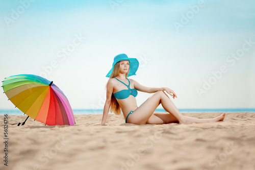 Beautiful woman on the beach by the sea
