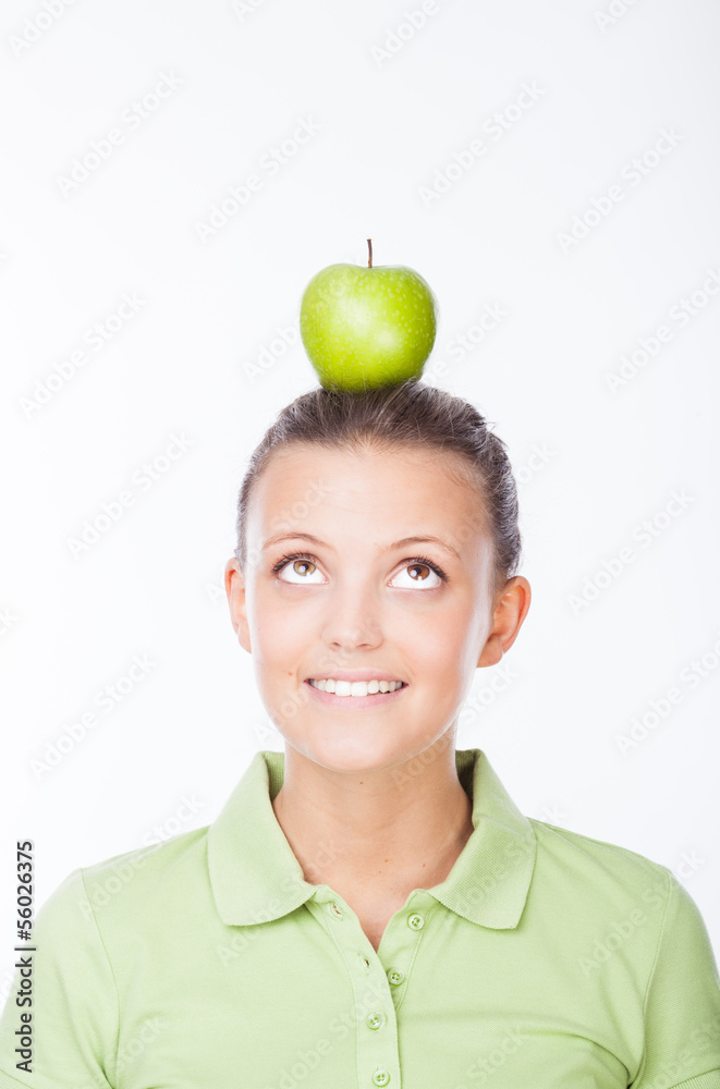Girl lookink at apple on her head Girl lookink at apple on her head