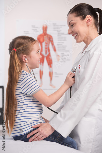 Wallpaper Mural Doctor and little girl. Cheerful little girl examining doctor wi Torontodigital.ca