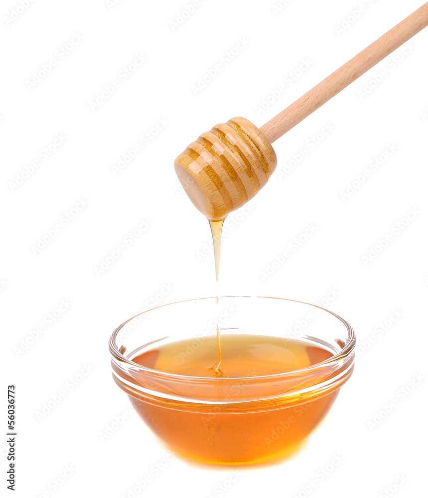 Honey dripping from a wooden dipper. Honey dripping from a wooden dipper.