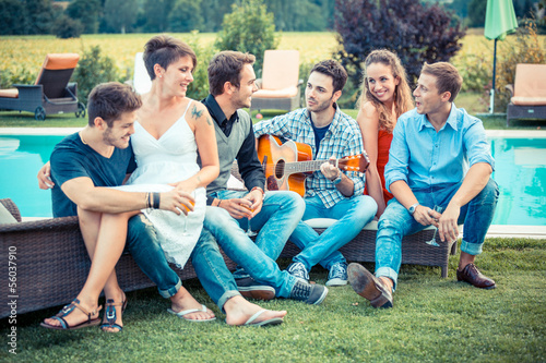 Group of Friend Singing Together next to Swimming Pool