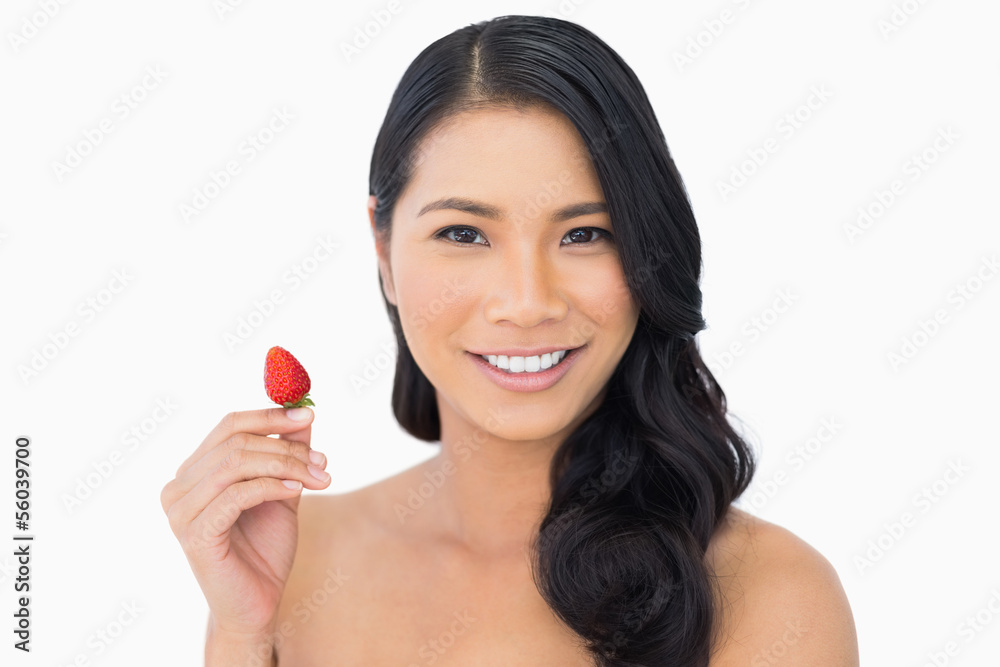 Natural brown haired model holding strawberry Natural brown haired model holding strawberry