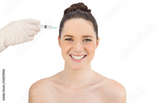 Cheerful natural model having injection on forehead