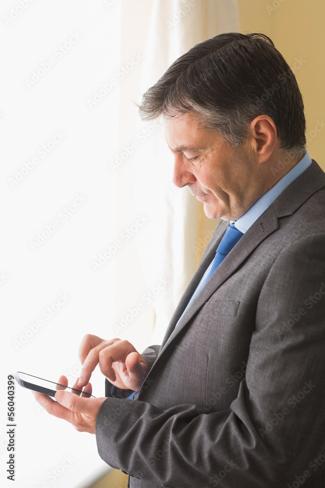Focused man texting on his mobile phone Focused man texting on his mobile phone