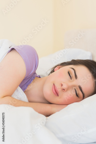 Happy girl sleeping in her bed