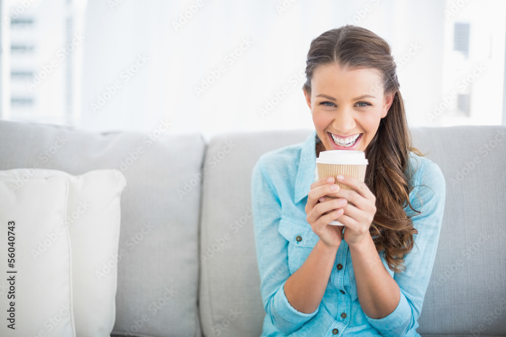 Pretty woman holding cup of coffee