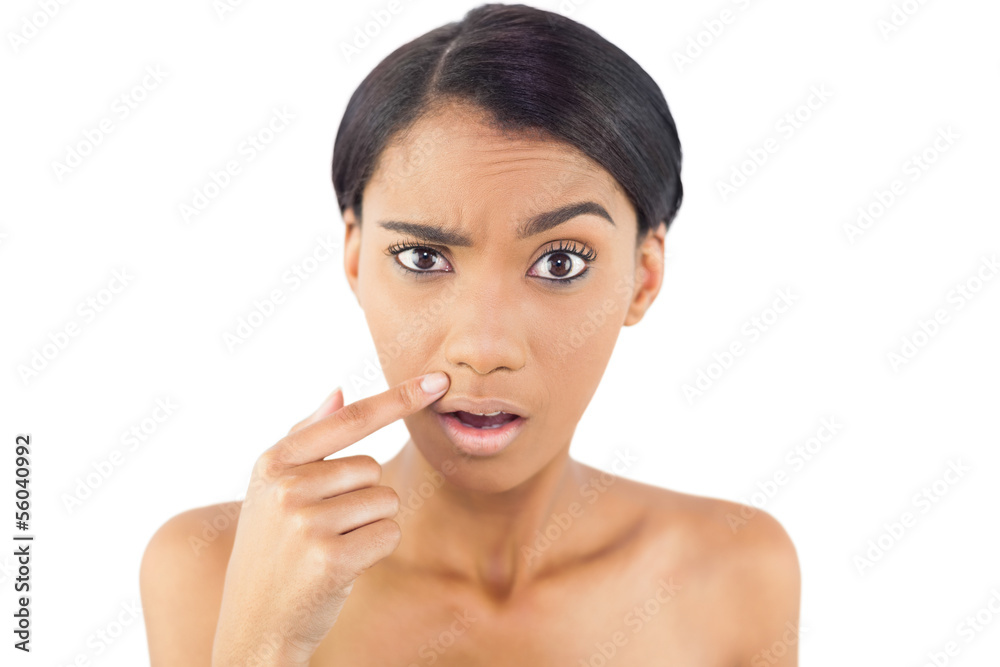 Gorgeous woman pointing at wrinkle above her lip Gorgeous woman pointing at wrinkle above her lip